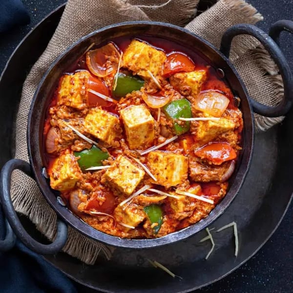 Curry Nation's Kadai Paneer, a vibrant Indian dish with paneer, bell peppers, and onions in a rich sauce.